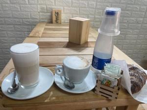 a table with a cup of coffee and a bottle of milk at casa catania termini home 4 in Catania