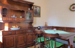 a dining room with a table and wooden cabinets at Mariza in Rošini