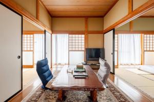 a living room with a table and a couch at Vacation Stay Fuji - 桜館 in Fujikawaguchiko