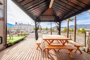 a wooden deck with a picnic table and a ping pong ball at Vacation Stay Fuji - 桜館 in Fujikawaguchiko