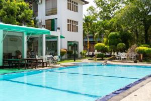 a swimming pool in front of a building at Yala Hotel Elephant Eye in Tissamaharama