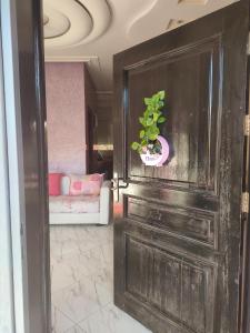 a door with a potted plant on top of it at Chez Adam in Meknès