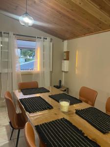 a dining room with a table with chairs and a window at Mon ti kréoline in Le Tampon +9 photos