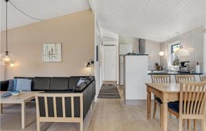 a living room with a couch and a table at Holiday Home Øster Kjulvej in Hirtshals