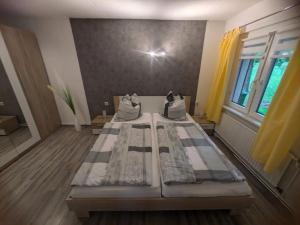 a large room with two beds in a room with a window at Fam Stana in Wienrode