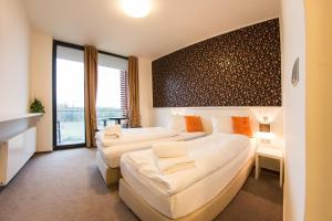 A bed or beds in a room at K-Triumf Resort