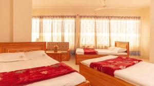 a bedroom with two beds and a window at Hotel Sikder Residential Mirpur in Bisil +14 photos