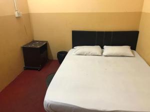 Postel nebo postele na pokoji v ubytování Motel Terminal Inn Inanam