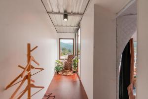 a hallway with a wooden table and a window at Ping fai camp inthanon in Chiang Mai