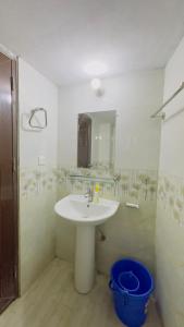 a bathroom with a sink and a mirror at Hotel Sikder Residential Mirpur in Bisil +14 photos