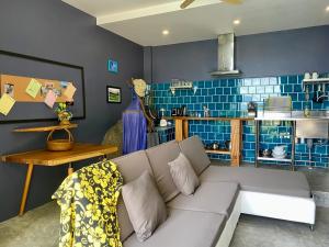 a living room with a couch and blue tiles at Ko Samui Seaview pool villa Paris with car in Laem Set Beach