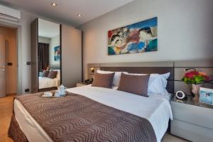 a bedroom with a large bed in a room at Fraser Place Antasya Istanbul in Istanbul