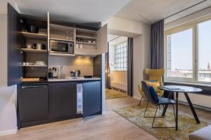 a kitchen with a table and chairs in a room at Numa Cologne Ehrenfeld in Cologne