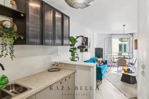 a kitchen with a sink and a living room at Argenteuil Moderne appartement pour 2 personnes in Argenteuil