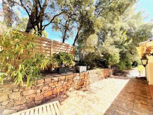 a stone retaining wall with a fence and a bench at Le Patio Bleu in La Crau +22 photos