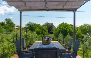 a table under an umbrella with a bowl of fruit on it at Villa Imela in Pula +37 photos