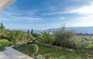 a garden with a view of the mountains at Amazing Apartment In Rabac With Kitchen in Rabac