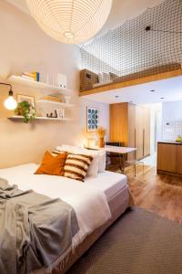 a bedroom with a large bed and a dining room at TurnKey I Charles Square Apartments in Prague