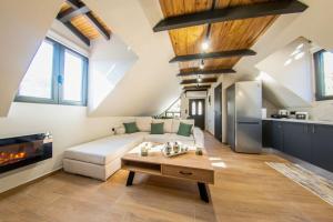 a living room with a white couch and a table at Roof Mountain Top in Kerpiní