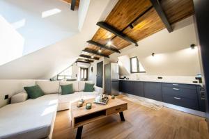 a living room with a couch and a table at Roof Mountain Top in Kerpiní +36 photos