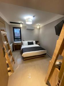 a bedroom with a bed and a tv in it at Utkubey Hotel in Gaziantep