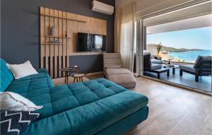 a living room with a blue couch and a view of the ocean at Villa Miracle in Split
