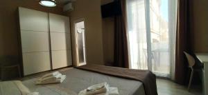 Postel nebo postele na pokoji v ubytování Giliberto Rooms