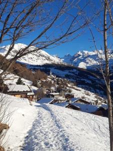 a snow covered mountain with a town in the distance at Accogliente casa in montagna in Champoluc