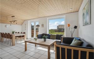 a living room with a couch and a table at Gorgeous Home In Harboøre With Sauna in Harboør
