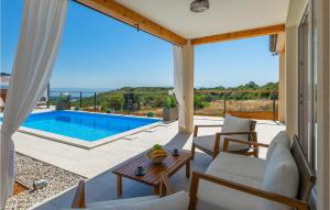a living room with a view of a swimming pool at Villa Veduta in Pula