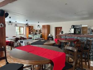 a restaurant with tables and chairs with red cloth on them at Weinesya Sunset Smida in Beliş