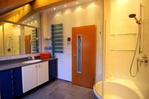 a bathroom with a tub and a sink and a shower at Studio A Am Burgberg in Erlangen +25 photos