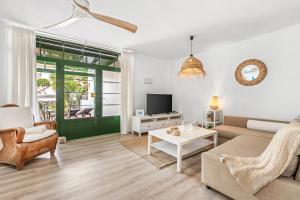 a living room with a couch and a table at Casa Yaiza in Puerto Calero