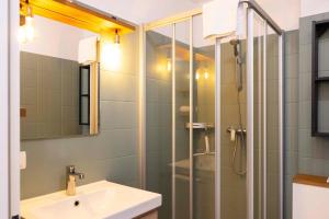 a bathroom with a sink and a shower at DKK1c Ferienwohnung Mole 1 in Niendorf +11 photos