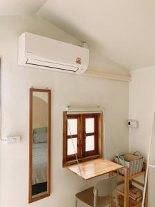 a room with a ceiling fan and a mirror at Monko Mini room in Pai +12 photos