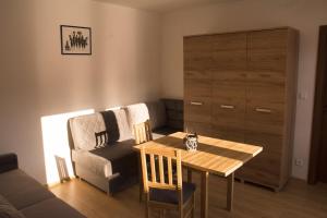 a living room with a table and a couch at Ubytovanie U Mirca in Nová ľubovňa