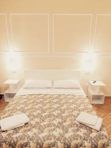 a bedroom with a bed with two pillows on it at Le Suite del Lungomare in Taranto