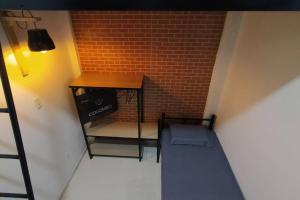 a room with a table and a brick wall at Apartamento em Lins - apto 02 in Lins