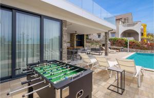 an outdoor entertaining area with a foosball table at 4 Bedroom Gorgeous Home In Lun in Lun +40 photos