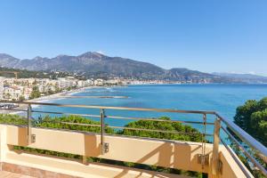 a balcony with a view of the ocean at Hôtel Alexandra in Roquebrune-Cap-Martin