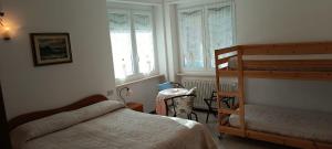 a bedroom with a bed and a bunk bed at B&B Home Sweet Home in Diano Marina
