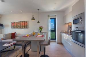a kitchen and dining room with a table and a couch at Fraser Place Antasya Istanbul in Istanbul