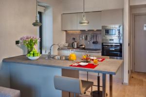 a kitchen with a island with a sink and a counter top at Fraser Place Antasya Istanbul in Istanbul