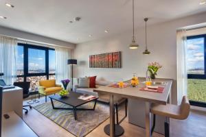 a living room with a table and a couch at Fraser Place Antasya Istanbul in Istanbul