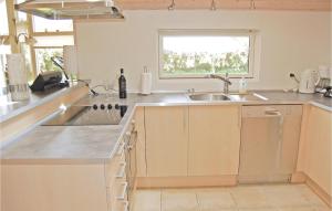 a kitchen with a sink and a counter top at Holiday Home Bogo By 34 With Hot Tub in Bogø By