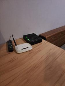a remote control and a game system on a wooden table at 2 Raumwohnung in Leipzig in Leipzig