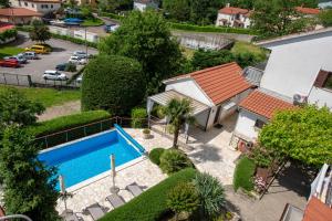 an overhead view of a swimming pool next to a house at Apartments Dorijan with Pool in Matulji