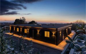 a house with a black roof on a wooden deck at Awesome Home In Knebel With Sauna in Knebel +36 photos