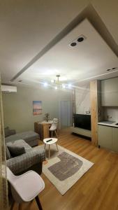 a living room with a couch and a table at Don Bosko Cozy Heaven Apartments 2 in Tirana