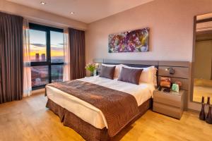 a bedroom with a large bed and a large window at Fraser Place Antasya Istanbul in Istanbul